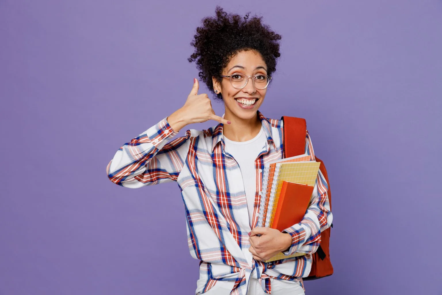 woman holding hand up to her ear to signify a phone