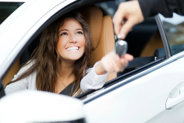 Handing keys to woman in car