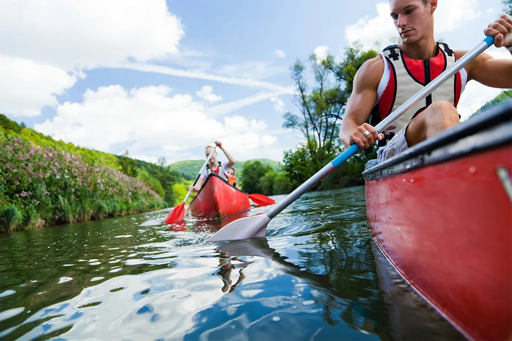 two canoes on the water with people in them