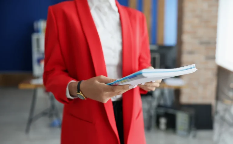 Professional woman holding stack of papers