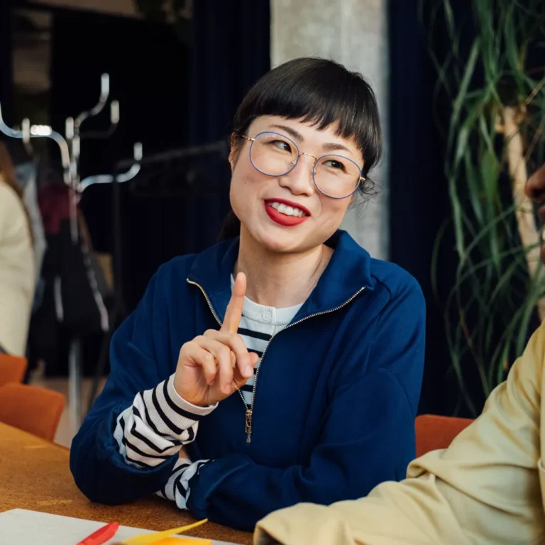 woman smiling and talking to person next to her