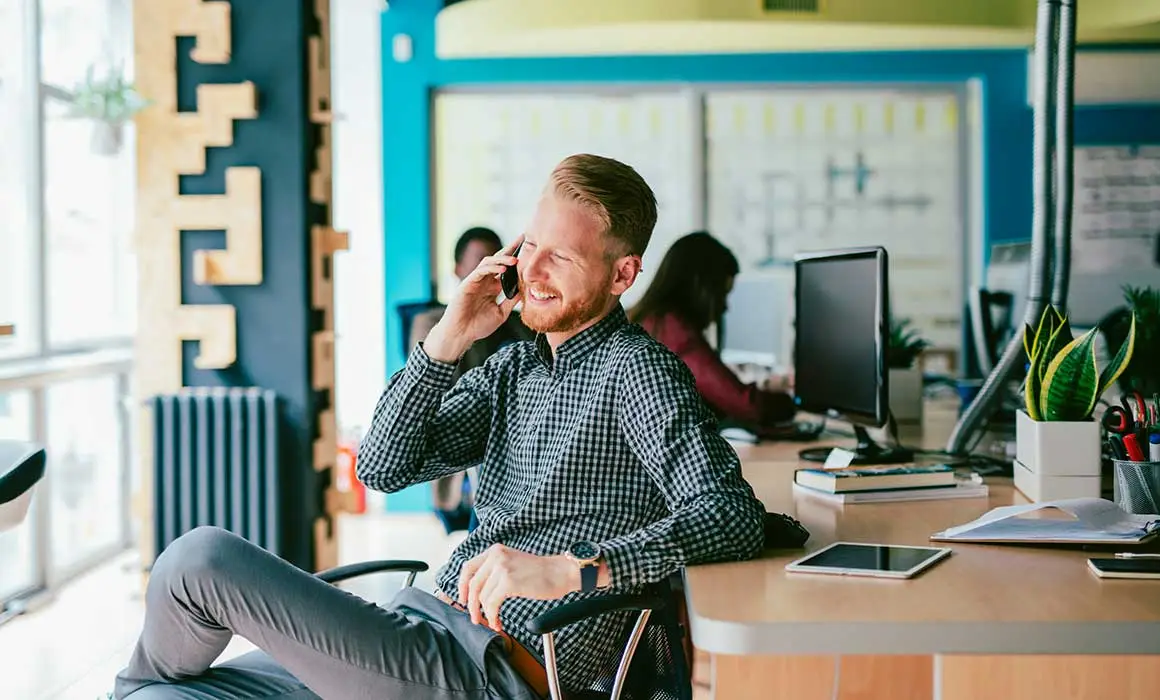 man smiling and talking on phone