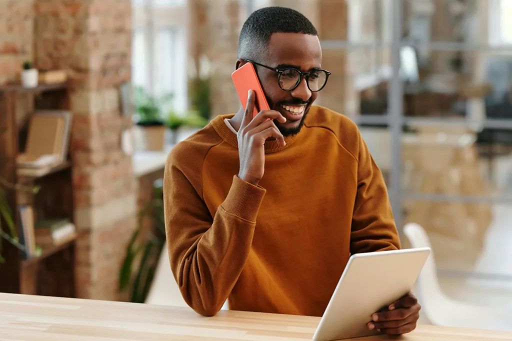 man smiling and talking on phone