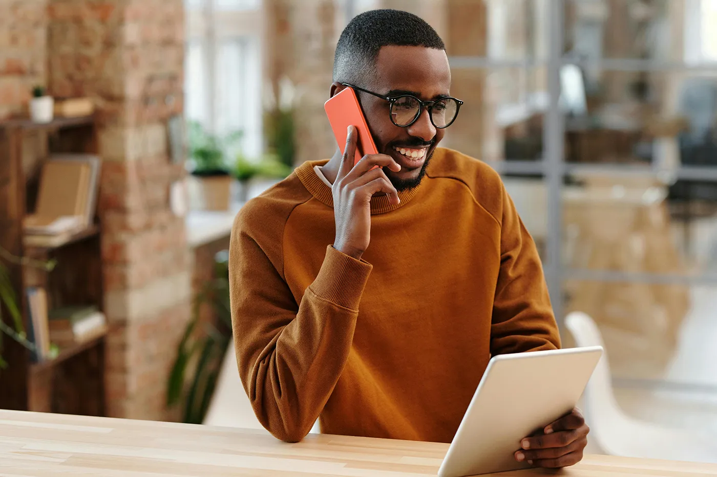 man smiling and talking on phone