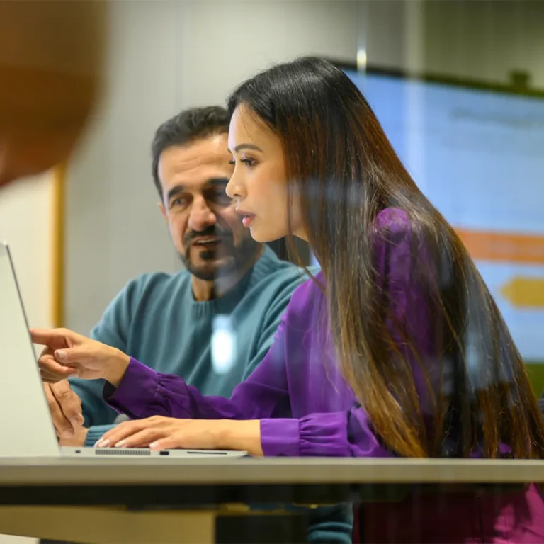 two people looking at laptop screen