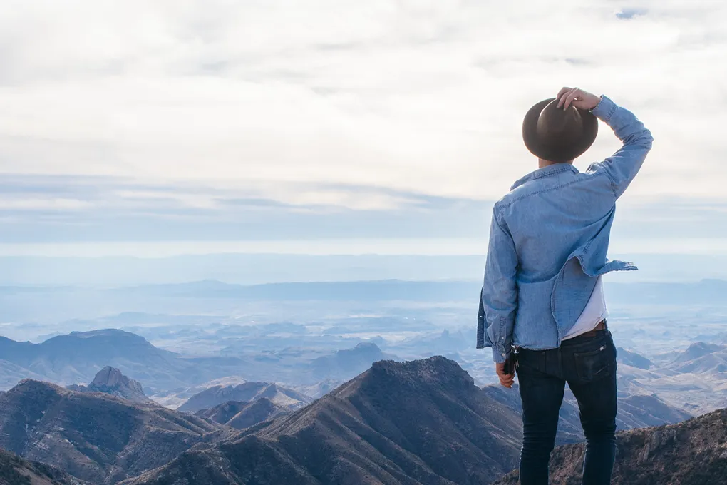 man overlooking mountains